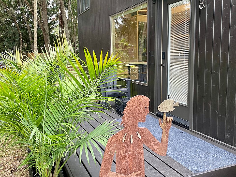 Escaperoo wooden deck and palms plus Pisces sculpture.