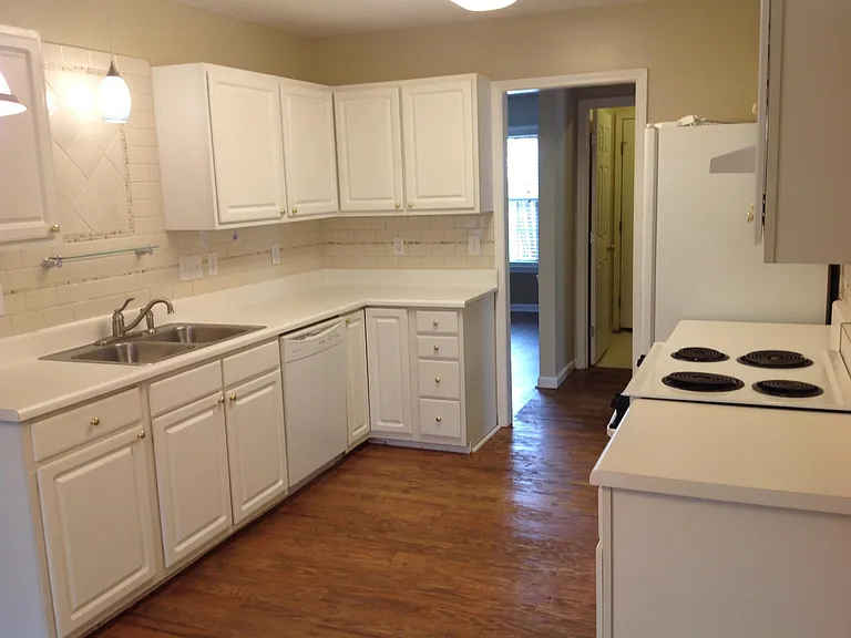 Ample cupboard space and counter work surface. Kitchen open but separated from living areas.