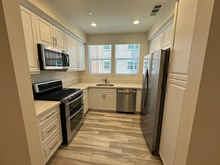 2nd floor: kitchen with refrigerator, oven/range, microwave, and dishwasher