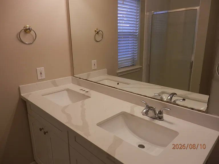 New cabinets and quartz countertop in primary bathroom