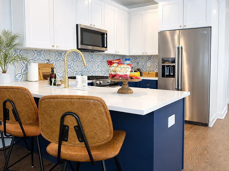The island seats 3 with extra dining space for easy gatherings.
