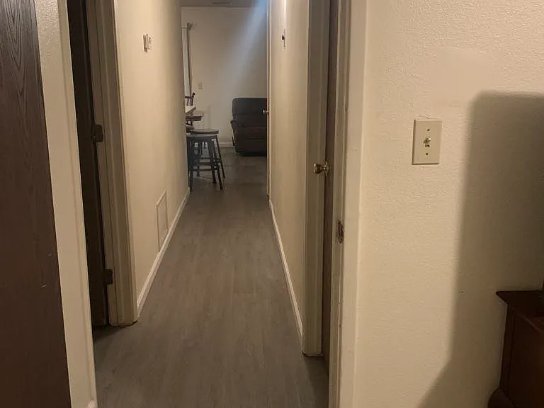 Hallway seen from master bedroom. Bathrooms are on the left, bedrooms on the right.