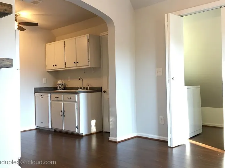 Dining room off kitchen with vaulted ceiling with washer and dryer 
(behind folding doors).