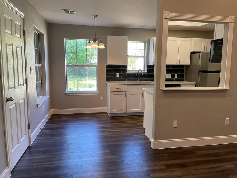 Beautifully remodeled chef's kitchen with quartz counter tops, stainless steel appliances and shaker cabinets