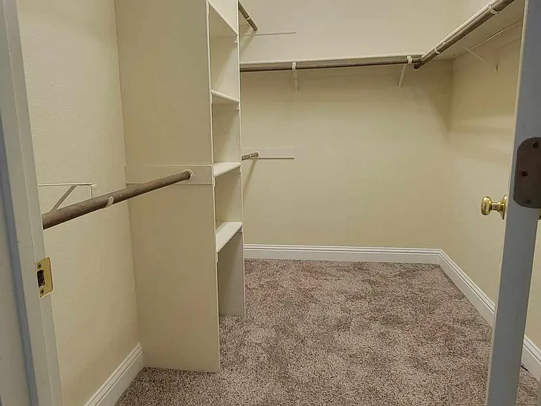 Master bathroom attached walk-in closet with ample rack space