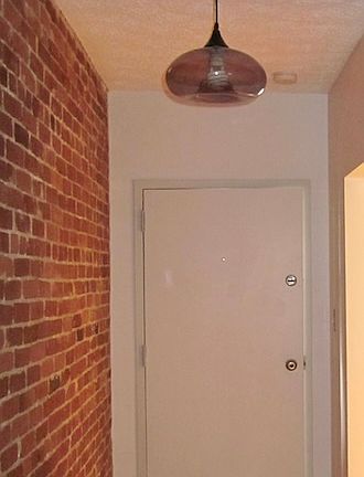 Front entrance hall with security intercom panel and closet.