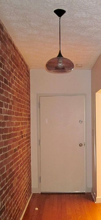 Front entrance hall with security intercom panel and closet.