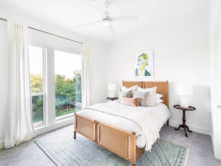 Primary bedroom with tall windows, soft finishes, and abundant natural light creating a bright, comfortable retreat in Dallas.