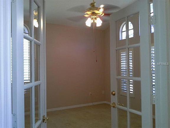 HOME OFFICE WITH FRENCH DOOR ENTRY AND PLANTATION SHUTTERS ON ARCHITECTURAL WINDOWS