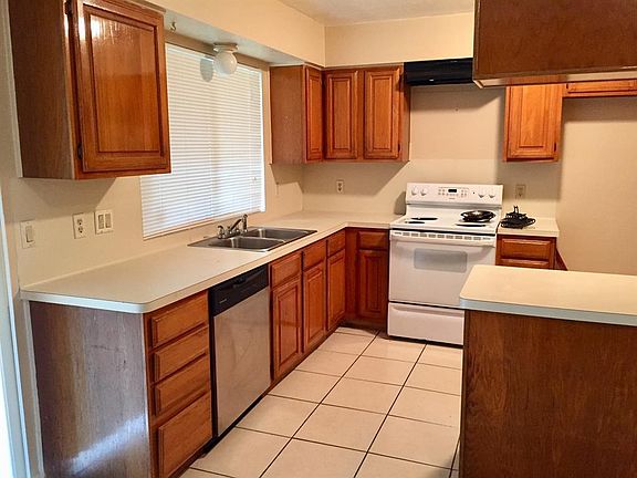 The kitchen has great countertop space and many cabinets.
