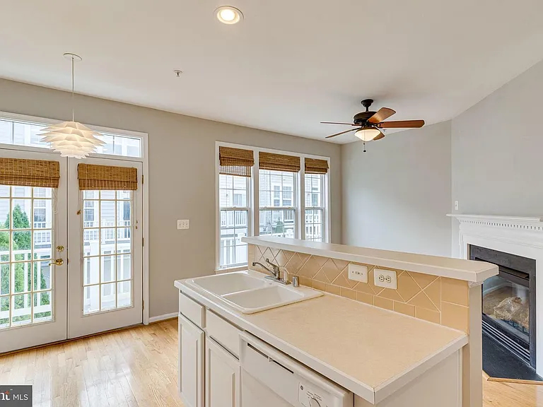 Kitchen great room w/ French doors to back balcony.