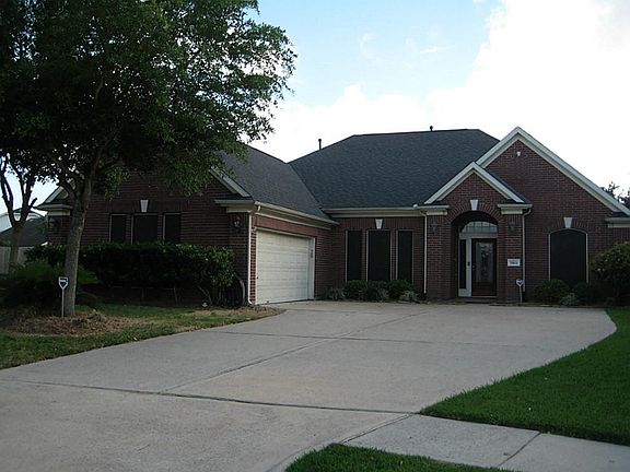 Lovely home with nice shade tree and long wide driveway.