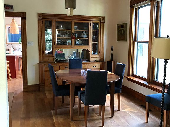 Dining room, with a glimpse of the kitchen beyond.