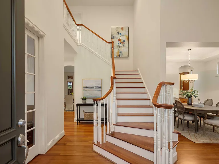 Staircase leading to 4 bedrooms at second floor. 2 bedrooms + Office on first floor.