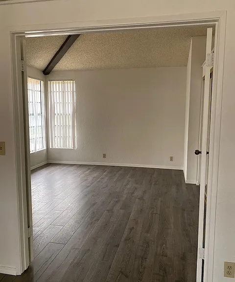 Spacious bedroom with a large mirrored closet.