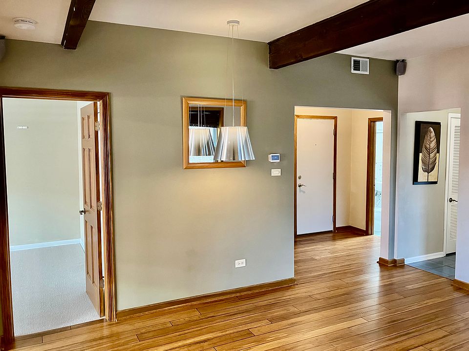 Dining room pendant light with doors to bedroom, foyer and kitchen