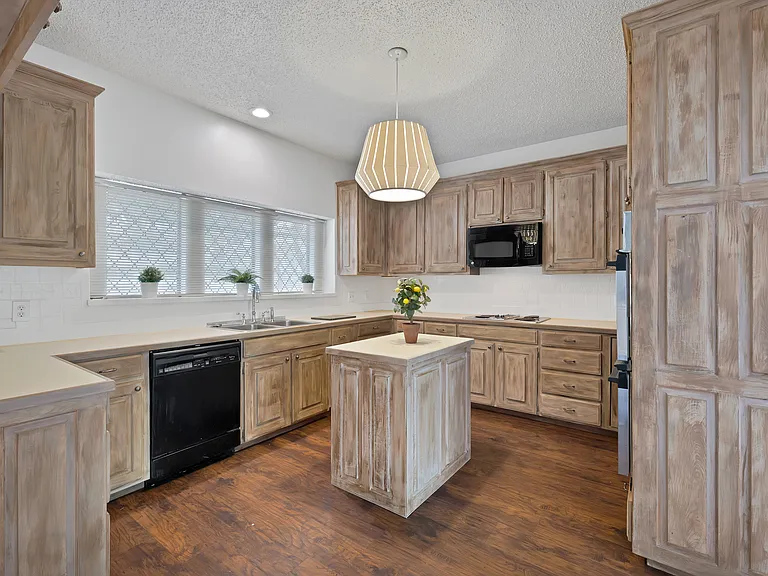 Kitchen with island, cooktop and wall oven. Need a fridge.