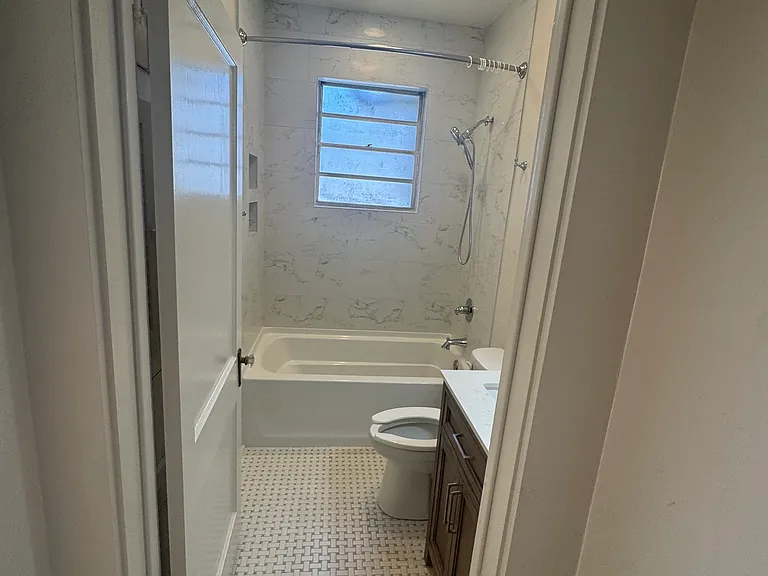 2nd bathroom with new tube, shower, vanity, toilet and tile flooring