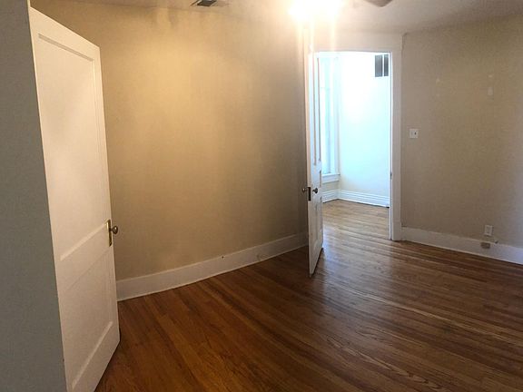 View of office, looking back toward hallway. Hallway leads to apartment entrance on the left. Toward the right is the kitchen entry then the bathroom access.