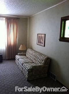 Living Room.
						:
						Newer carpet and stain glass window.