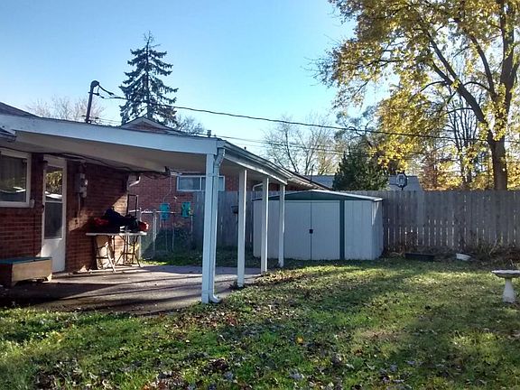 Patio and large storage shed with privacy fence. Fenced yard.