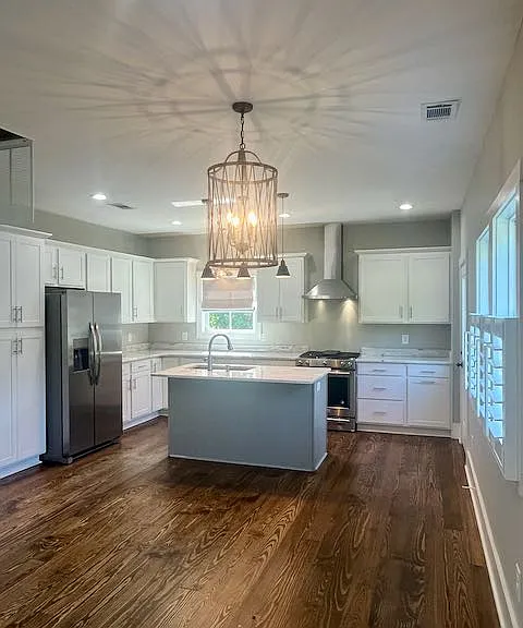 Kitchen/Dining has unique light fixtures. Gas stove w/ electric oven, dishwasher & ice maker in fridge