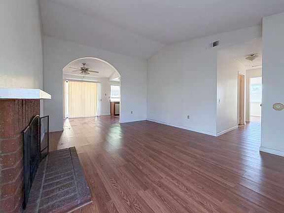 Living - Hallway to Bedrooms on the near right. Dining and kitchen after arched opening.