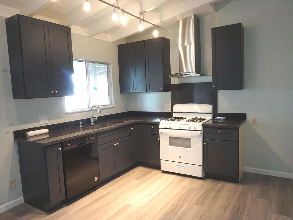 Brand new kitchen with brand new dishwasher, stove, and refrigerator