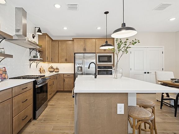 Kitchen with floating shelves and pendant lights