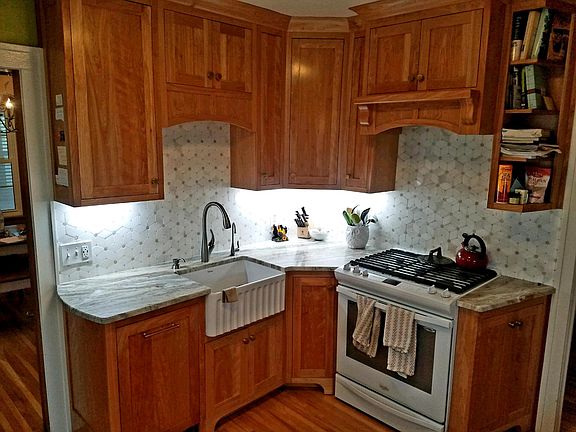 New Custom Kitchen with red birch cabinets, marble tile, granite countertops and farm sink.