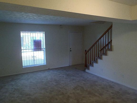 Living room and entry. Stairs lead to two master bedrooms.