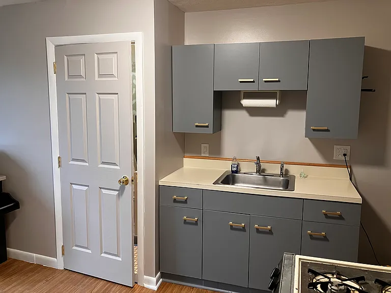 Half of kitchen, bathroom door. New tile with lots of storage.