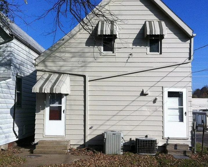 Photo is taken from the back of house. door to upstairs is located on the right. Off street parking off alley