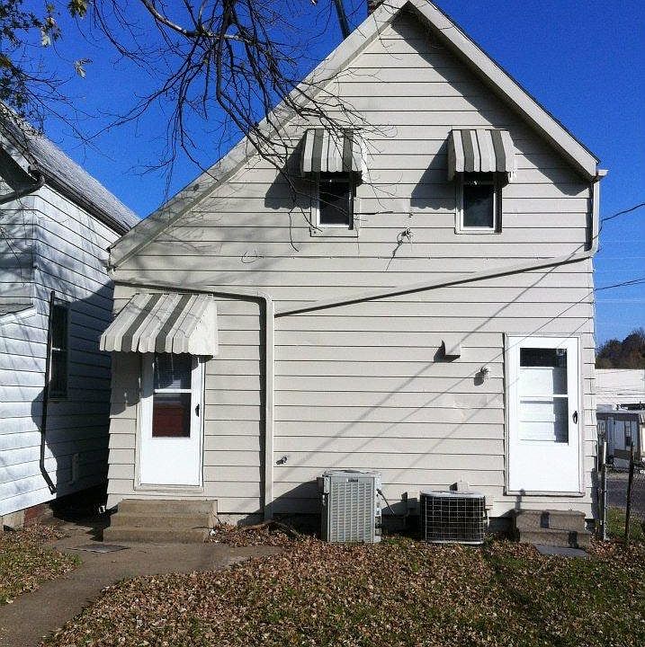 Photo is taken from the back of house. door to upstairs is located on the right. Off street parking off alley