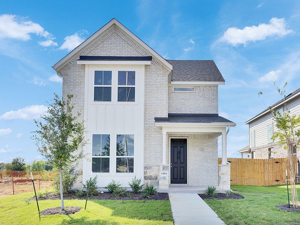 Distinctive brick facade and ample windows showcase modern elegance at this Creeks Crossing residenc
