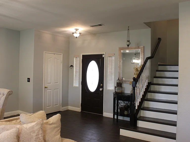 Durable tile flooring downstairs with a laminate staircase