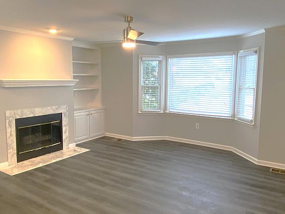 LIVING ROOM WITH BAY WINDOW AND FIREPLACE