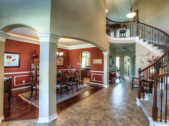 Dramatic Curved Staircase Sets Off This Stunning Two-Story Foyer!
