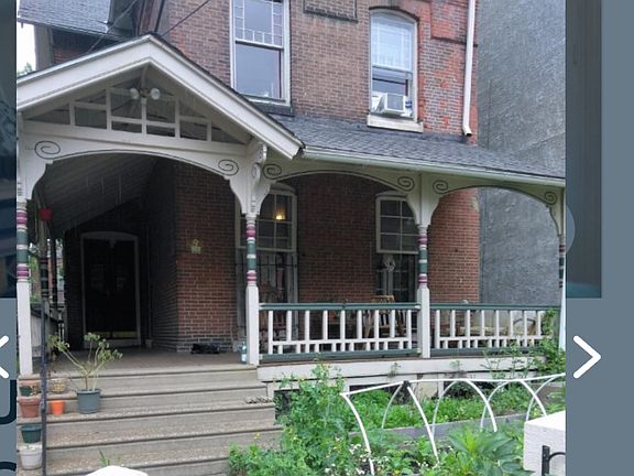 Front of home with one of 3 garden spaces