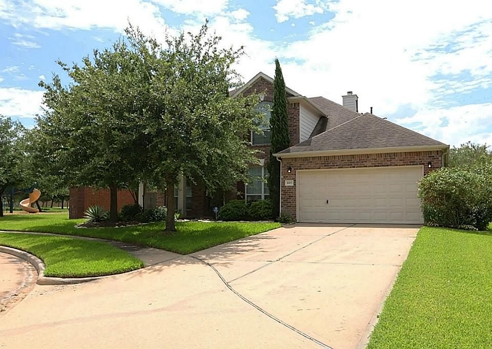 Front of home with large tree. Provides natural shade to front of home and front porch.