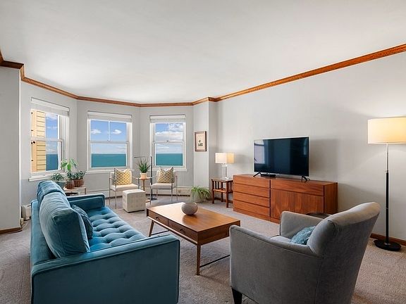 The large living room has beautiful views of the lake and a bay window.