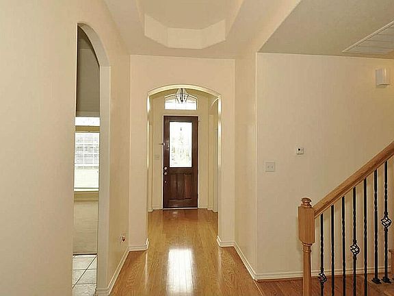 Rich real wood floored foyer. Etched leaded glass & walnut front door with transom for natural light. Opens to formal living & dining room. French doors to study. SEE VIRTUAL TOUR!