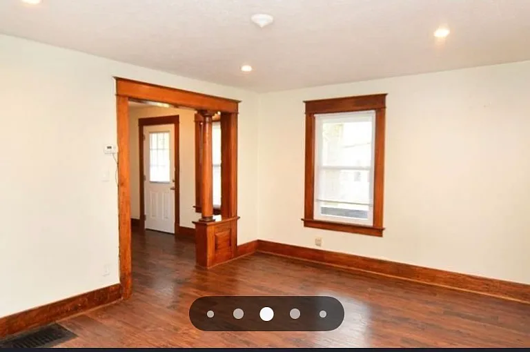 Living room looking towards landing area and side entrance.