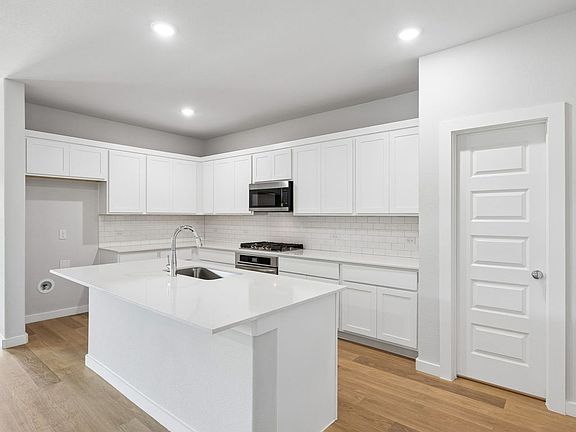 Kitchen in the Oscar home plan by Trophy Signature Homes - REPRESENTATIVE PHOTO