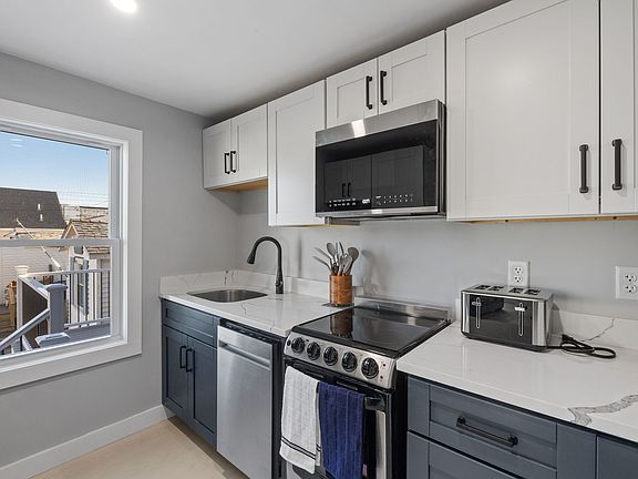 Kitchen has fridge/freezer, dishwasher, electric range, microwave, coffee maker, and toaster.