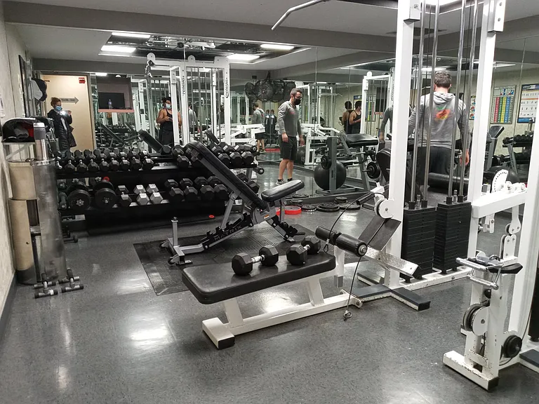 Fitness center with free weights, cardio equipment and weight machines.