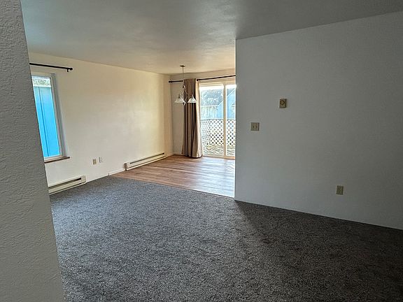 Living area leading to dining area and kitchen on 2nd floor