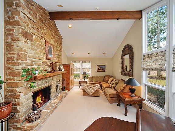 Vaulted ceilings, tall windows and a floor to ceiling stone fireplace.