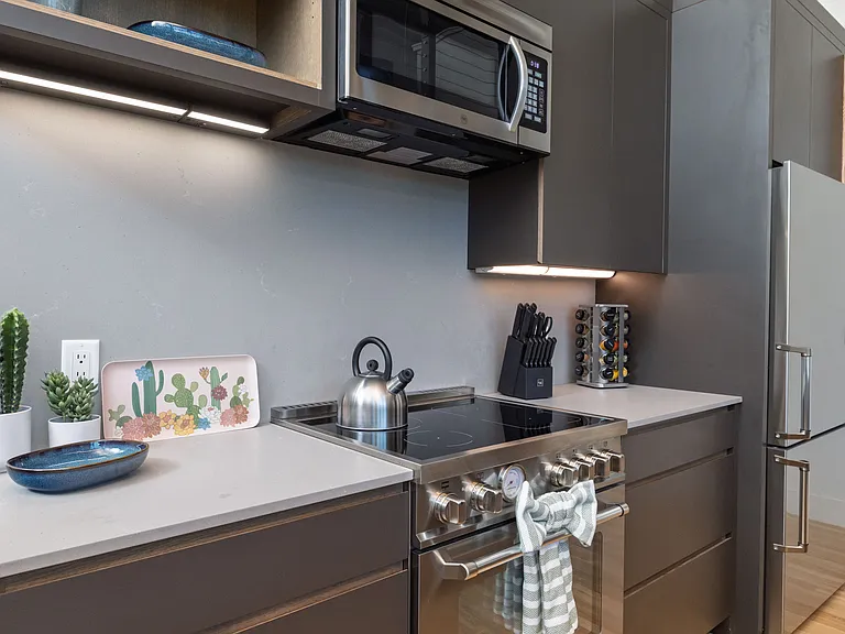 Open concept kitchen with seating for 4 at the kitchen island. The kitchen is fully stocked and ready to use.