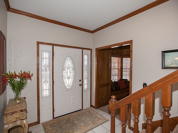 Entry area overlooking large Den with wood burning fireplace